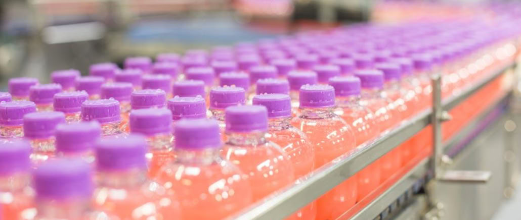 Energy shot bottles prepared for hot filling at Nutrition Labs beverage co-packing facility
